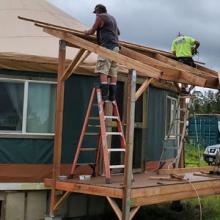 Constructing an overhang over the entrance to one of the yurts